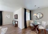 Located at 3001 Hahn Dr in Modesto, California, this single-story, one-bedroom, one-bathroom home offers a well-designed layout across a comfortable and functional floor plan. Wood-look flooring runs throughout the main living areas, lending warmth and cohesion to the space.

The living room is bright and welcoming, featuring multiple windows dressed with dark curtain panels that allow for adjustable natural light. A sliding glass door opens directly to a private outdoor patio, seamlessly connecting interior and exterior living. The dining area sits adjacent to the living room, illuminated by a pendant light fixture overhead.

The kitchen is efficiently laid out with white cabinetry, light stone-finish countertops, and stainless steel appliances. Ample counter space on both sides creates a practical galley-style workspace ideal for everyday cooking.

The generously sized primary bedroom is carpeted for comfort and features multiple windows with outdoor views and blackout-style curtain panels. It offers a calm, restful atmosphere with plenty of room to furnish.

The bathroom is clean and well-appointed, featuring a white vanity with stone-finish countertops, a tub-shower combination, and wood-look flooring. The space also includes a dedicated closet, two hallways for smooth circulation, and a textured ceiling detail throughout.