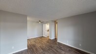 Located at 201 W California Ave in Sunnyvale, CA, this single-floor unit offers a clean, modern aesthetic throughout. The open-concept living and dining area is finished with rich, dark wood-look flooring and neutral gray walls, creating a bright and versatile space. A ceiling fan overhead adds comfort, while a sliding glass door allows natural light to fill the room and provides access to the exterior.

The kitchen is well-appointed with white shaker-style cabinetry, dark countertops, and a full suite of stainless steel appliances including a refrigerator, electric range, microwave, and dishwasher. Ample upper and lower cabinet storage ensures generous functionality for daily living.

The bedroom features plush wall-to-wall carpeting, a textured ceiling, and a window that brings in natural light. A closet provides convenient storage directly off the room. An additional area with hardwood-style flooring and large windows offers flexible use as a secondary living or dining space, complete with a wall-mounted HVAC unit.

The bathroom is outfitted with a full tub and shower combination with chrome fixtures, set against clean white surroundings. A dedicated in-unit laundry closet adds practical convenience. Throughout, textured ceilings and crisp white trim tie the spaces together for a cohesive, move-in-ready feel.