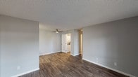 Located at 201 W California Ave in Sunnyvale, CA, this single-floor unit offers a clean, modern aesthetic throughout. The open-concept living and dining area is finished with rich, dark wood-look flooring and neutral gray walls, creating a bright and versatile space. A ceiling fan overhead adds comfort, while a sliding glass door allows natural light to fill the room and provides access to the exterior.

The kitchen is well-appointed with white shaker-style cabinetry, dark countertops, and a full suite of stainless steel appliances including a refrigerator, electric range, microwave, and dishwasher. Ample upper and lower cabinet storage ensures generous functionality for daily living.

The bedroom features plush wall-to-wall carpeting, a textured ceiling, and a window that brings in natural light. A closet provides convenient storage directly off the room. An additional area with hardwood-style flooring and large windows offers flexible use as a secondary living or dining space, complete with a wall-mounted HVAC unit.

The bathroom is outfitted with a full tub and shower combination with chrome fixtures, set against clean white surroundings. A dedicated in-unit laundry closet adds practical convenience. Throughout, textured ceilings and crisp white trim tie the spaces together for a cohesive, move-in-ready feel.