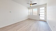 This contemporary 640 square foot apartment in Rio Rancho, NM offers a harmonious blend of style and functionality. The open-concept design seamlessly integrates the kitchen and living area, creating an airy and spacious atmosphere. The kitchen boasts pristine white cabinetry, stainless steel appliances, and a generous island with a sink, perfect for both meal preparation and casual dining.

The bathroom exudes elegance with its marble-inspired shower surround, modern vanity, and wood-look flooring that extends throughout the apartment. The bedroom, measuring 130 square feet, features large windows that flood the space with natural light and a ceiling fan for comfort.

Storage is ample, with a walk-in closet and additional overhead storage in the attached garage. The garage itself is well-lit and offers convenience for vehicle parking or additional storage needs.

Throughout the apartment, neutral tones and wood-look flooring create a cohesive and contemporary aesthetic. Recessed lighting and modern fixtures add to the overall ambiance. Large windows in the living area and bedroom not only brighten the space but also offer views of the surrounding area.

This efficient one-floor layout maximizes every square foot, making it an ideal choice for those seeking a modern, low-maintenance living space in a desirable location.