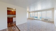 Located at 6340 Stumph Rd in Parma Heights, Ohio, this single-floor residence offers a thoughtfully laid-out living space with a blend of comfort and functionality. The expansive living room is a standout feature, highlighted by plush wall-to-wall carpeting, a ceiling fan, and a textured ceiling that adds character. Large sliding glass doors and wide windows flood the room with natural light and provide direct access to a private balcony overlooking the surrounding landscape. Baseboard heating and a wall-mounted air conditioning unit ensure year-round comfort. The kitchen is well-appointed with rich warm-toned wood cabinetry, stone-look countertops, hardwood-style flooring, and white appliances including a dishwasher, range, and refrigerator — offering ample storage and prep space. The bedroom is generously sized with soft carpeting, closet access, and a calm, neutral palette. The bathroom features a full tub-shower combination with clean white tile surround, a white vanity, and hardwood-style flooring, maintaining a crisp and tidy aesthetic throughout. The layout flows naturally between spaces, making efficient use of the single-floor design. The overall ambiance is bright, clean, and move-in ready.