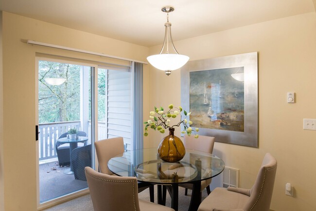 Open Dining area with overhead lighting and large sliding glass doors leading out to the balcony - Windsong