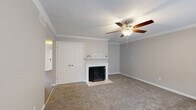 This well-appointed 2-bedroom, 2-bathroom single-story home in Memphis, Tennessee offers a thoughtfully designed layout with a comfortable, functional flow throughout. The living room serves as the heart of the home, featuring a classic wood-burning fireplace with a white mantle, crown molding, a textured ceiling, and a ceiling fan — all set over plush carpeting that extends through the main living areas. A large front-facing window fills the entry area with natural light. The kitchen is a standout, outfitted with white shaker cabinets, granite countertops, stainless steel appliances, and a raised breakfast bar that opens to the dining area. Hardwood-style flooring runs through the kitchen and dining spaces. Both bedrooms are generously sized, each with ceiling fans and carpeted floors. The primary bedroom includes a walk-in closet with built-in shelving. The bathrooms are clean and functional — one features a granite-topped vanity with white cabinetry, while the other includes a tub-shower combination with tile surround. Additional highlights include five closets, a dedicated pantry, in-unit laundry, and a private patio. The home is situated in the 38119 zip code of Memphis, TN.