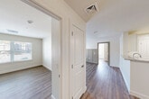 Located at 1 Ridge Rd in Auburn, MA, this single-floor, 2-bedroom, 2-bathroom residence offers a thoughtfully designed layout with modern finishes throughout. Wood-style plank flooring runs continuously through the living areas, hallways, and bedrooms, lending the space a clean, cohesive aesthetic.

The combined kitchen and dining area serves as a central hub, featuring white shaker-style cabinetry, granite-look countertops, stainless steel appliances including a French-door refrigerator and range, and recessed lighting that creates a bright, functional workspace.

The living room is highlighted by a decorative wainscoting wall with panel molding, adding a refined architectural detail to the otherwise neutral, modern interior. Natural light enters through windows dressed with horizontal blinds, offering views to the outside.

The primary bedroom is a comfortable retreat, with a dedicated window and ample floor space. The second bedroom mirrors this layout with its own window and natural light. Five closets distributed throughout the unit provide generous storage.

Both bathrooms are finished with granite-topped vanities and cream cabinetry. One bathroom features a full tub-shower combo, while the other offers a walk-in shower. Additional conveniences include a dedicated laundry area and a utility room, rounding out this practical and well-equipped residence.