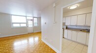 Located at 14 Dublin St in Markham, Ontario, this one-bedroom, one-bathroom unit offers a practical and well-organized layout across a single floor. Classic parquet hardwood flooring runs throughout the main living areas and bedroom, lending warmth and a timeless character to the interior.

The combined living and dining area is the heart of the unit, featuring large windows that invite generous natural light and provide views of the surrounding neighbourhood. The open feel of the space makes it versatile for both relaxing and entertaining.

The kitchen is positioned adjacent to the living area and is equipped with white cabinetry, granite-style countertops, a white electric range, and tile flooring. A pass-through opening connects the kitchen to the rest of the unit, maintaining a sense of flow and openness.

The bedroom is a well-proportioned private retreat, continuing the parquet flooring and featuring a full-width sliding door closet that maximizes storage. A window allows for natural light and ventilation.

The bathroom is finished in a clean, bright palette with white subway tile surrounding the bathtub and shower, light tile flooring, a white vanity with modern hardware, and a toilet — all maintaining a cohesive, fresh aesthetic throughout.