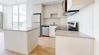 Located at 202 Burnhamthorpe Rd E in Mississauga, this modern 2-bedroom, 2-bathroom unit offers a bright and contemporary living experience with a thoughtfully designed open layout. Light hardwood flooring flows throughout the space, complementing the clean white walls and creating a cohesive, airy ambiance.

The kitchen is well-appointed with flat-panel cabinetry in a soft neutral tone, stainless steel appliances including a refrigerator, stove, microwave, and dishwasher, along with a subway tile backsplash and a peninsula that provides additional workspace and storage.

The primary bedroom is generously sized, featuring floor-to-ceiling sliding glass doors that open to a private balcony with views of the surrounding cityscape. The second bedroom benefits from a large picture window that frames sweeping views of the green landscape below, filling the room with natural light.

Both bathrooms are finished with modern fixtures and tilework. The main bathroom includes a soaker tub with full-height stone-look tile surround, while the second bathroom features a sleek vanity with an undermount sink. A mirrored sliding-door closet in the entryway adds practical storage. Built-in closets in the bedrooms further enhance functionality throughout this well-designed urban residence.