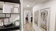 Located in the northwest Edmonton community of Laubman Street, this well-designed 2-bedroom, 2-bathroom unit offers a thoughtfully arranged single-level floor plan. Light-toned luxury vinyl plank flooring flows throughout, complementing the crisp white walls and modern finishes seen across every room.

The open-concept living, dining, and kitchen area forms the heart of the unit. The kitchen is outfitted with two-tone cabinetry — white uppers paired with warm wood-finish lowers — stainless steel appliances including a built-in microwave and electric range, a subway tile backsplash, and a central island with white quartz countertops and bar seating. Pendant lighting and recessed pot lights illuminate the space. The dining area accommodates a full-sized table and benefits from large windows overlooking the patio. The living room features generous windows that bring in natural light.

A well-lit hallway connects the private quarters, where two bedrooms each include closets. The primary bedroom offers a double-door closet and direct access to the hallway. Both bathrooms are clean and functional, with one featuring a full soaker tub and tiled surround. In-suite laundry adds convenience. The private patio, framed by stone exterior cladding, provides outdoor access and neighbourhood views.