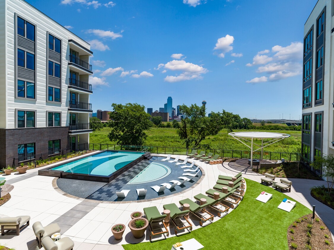 Dive into fun at Modera Trinity's resort-style pool and enjoy a game of Cornhole! Where leisure meets play, right by the poolside. - Modera Trinity