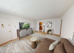 Located at 1275 Gerling Street in Schenectady, NY, this single-floor apartment offers 620 square feet of living space across three bedrooms, one bathroom, a kitchen, and a hallway. The unit features a clean, neutral aesthetic throughout, with white walls and beige carpeting in all bedrooms and common areas. The primary bedroom measures a spacious 220 square feet and includes double closets, providing ample storage. The additional bedrooms feature carpeted floors, radiator heating units, and windows with horizontal blinds that allow natural light. The kitchen is well-appointed with warm oak cabinetry, dark granite-style countertops, a gas range, built-in microwave, refrigerator, and tile flooring — all topped with a ceiling fan and a window for ventilation. The bathroom is finished with white ceramic tile flooring, a white vanity with an integrated sink, a toilet, and a mirror, presenting a clean and functional layout. Textured ceilings are consistent throughout the unit. Radiator heating is present in multiple rooms, ensuring efficient warmth. A connecting hallway provides organized access to all rooms, making the layout practical and straightforward for everyday living.