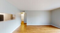 Located at 6425 Bankside Dr in Houston, TX, this single-story, 3-bedroom, 2-bathroom home offers a functional and well-organized layout across a comfortable footprint. The living room is bright and open, featuring warm hardwood-style flooring, soft neutral wall tones, and a pass-through opening that connects to the kitchen area, lending an airy, connected feel to the main living space. Built-in cabinetry adds a thoughtful touch to the living room. The kitchen is efficiently designed with white cabinetry, light speckled countertops, a stainless steel sink, and black appliances including a refrigerator and range. It opens directly into the living and dining areas, making it ideal for everyday living. The primary bedroom is a generously sized retreat featuring plush carpeting, dual closets, and ample wall space. The additional bedrooms are well-proportioned, with hardwood-style flooring and natural light from exterior windows. Both bathrooms are clean and functional, each featuring a tiled tub-shower combination with chrome fixtures and wood-style flooring. A hallway connects the bedroom wing to the main living areas, and a dedicated closet provides additional storage. The home's consistent neutral palette and clean finishes create a cohesive, move-in-ready atmosphere throughout.