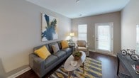 Located at 660 Bonterra Blvd in Fort Wayne, Indiana, this single-floor residence offers a thoughtfully designed layout that balances comfort and modern style throughout. The living area sets a welcoming tone with warm neutral walls, rich hardwood-style flooring, and generous natural light filtering through slatted blinds. A door leads to an outdoor area, enhancing the sense of openness. The kitchen is a standout feature, showcasing rich dark espresso cabinetry, granite countertops, stainless steel appliances, and a peninsula with pendant lighting overhead — ideal for both cooking and casual dining. Track lighting illuminates the workspace, adding a contemporary touch. The bedroom offers a tranquil retreat, complete with plush carpeting, neutral tones, and a window that invites natural light. An additional carpeted room provides flexible space for various uses. The bathroom mirrors the kitchen's elevated aesthetic, featuring matching dark cabinetry, granite countertops, a large vanity mirror, and hardwood-style flooring. Consistent finishes and a cohesive neutral color palette with warm accent tones tie the entire residence together, creating a refined and comfortable living environment.