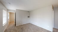 Located in Saginaw, TX, this single-story 2-bedroom, 2-bathroom home offers a practical and well-organized layout. The combined living and dining area provides an open, versatile space finished with neutral-toned carpet and a textured ceiling. Natural light enters through a blinds-covered window near the front entrance, creating a bright and welcoming atmosphere. The galley-style kitchen is efficiently designed with white cabinetry, white countertops, a double-basin sink, a dishwasher, and stainless steel appliances including a refrigerator and range, all set over warm wood-look flooring. A dedicated laundry area and multiple closets add practical storage throughout. Both bedrooms feature carpet flooring, ceiling fans with light fixtures, and windows with blinds that allow for natural light. The primary bedroom is generously sized and benefits from two closets. Each bathroom is functional and clean: one features a tub/shower combo with white tile surround and wood-look flooring, while the other includes a vanity with white cabinetry and a well-lit mirror. The neutral gray and white color palette throughout the home lends a cohesive, move-in-ready feel.