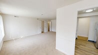 Located at 920 Som Center Rd in Mayfield, OH, this single-floor unit offers four bedrooms, two bathrooms, a kitchen, and two closets across a well-organized layout. The living area is bright and open, featuring large windows with vertical blinds that invite generous natural light and outdoor views, with neutral carpet flooring throughout.

The standout kitchen has been thoughtfully updated with crisp white shaker cabinetry, light granite countertops, wood-look flooring, and a full suite of stainless steel appliances including a gas range, microwave, and refrigerator. A tray ceiling detail adds architectural interest to the space.

The primary bedroom is notably spacious, offering ample room for furnishings, and includes access to closets. The additional three bedrooms each feature carpet flooring and windows that bring in natural light, providing comfortable and versatile spaces.

Both bathrooms maintain a clean, functional design with white vanities, updated brushed nickel fixtures, mirrors with overhead lighting, and wood-look flooring. One bathroom features a shower with glass sliding doors. The overall palette throughout is neutral and bright, with white walls and light-toned flooring creating a consistent, airy ambiance across every room.