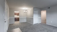 Located at 921 Lake Village Dr in Chesapeake, Virginia, this single-floor residence offers a well-organized and functional layout throughout. The open living and dining area features neutral-toned walls, plush wall-to-wall carpeting, and a chandelier overhead, creating a welcoming atmosphere. The space flows naturally into the kitchen, which is outfitted with rich dark wood cabinetry, light granite-style countertops, light wood-look flooring, and a white gas range with oven — providing a practical and attractive cooking environment. The bedrooms are generously sized, each with soft carpeting and built-in closets featuring rod and shelf storage. Several bedrooms include windows with exterior views of the surrounding greenery, allowing natural light to fill the rooms. The bathroom is clean and straightforward, equipped with a full soaking tub and shower combo with tiled surround. Throughout the home, neutral wall tones and consistent flooring choices create a cohesive and move-in-ready aesthetic. The single-story layout ensures easy accessibility, making this Chesapeake residence a practical and comfortable place to call home.