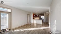 This well-appointed 2-bedroom, 2-bathroom residence in Honea Path, SC offers a thoughtfully designed single-floor layout with a modern aesthetic throughout. The open-concept kitchen is a standout feature, showcasing rich wood-toned cabinetry, white quartz countertops, a tile backsplash, and a full suite of stainless steel appliances including a French door refrigerator, electric range, built-in microwave, and dishwasher. Pendant lighting and track lighting illuminate the space, which flows seamlessly into the living area. Durable wood-look flooring runs through the main living spaces, while plush carpet adds warmth to the bedrooms. The primary bedroom is generously sized, filled with natural light from large windows, and features a ceiling fan and direct access to an en-suite bathroom. The bathrooms are finished with dark wood vanities, dual sinks, white countertops, and tiled shower/tub combinations. Storage is abundant, with five closets throughout, including walk-in closets fitted with wire shelving systems. A private balcony offers open views of the surrounding neighborhood and landscape under open skies. A dedicated laundry area and connecting hallway complete this functional and stylish home.