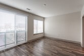 Located at 1901 Oak St in Kansas City, Missouri, this single-floor residence offers a thoughtfully designed layout with modern finishes throughout. Rich wood-look flooring flows seamlessly across the entire space, creating a warm and cohesive aesthetic in every room.

The kitchen is a standout feature, showcasing granite countertops, rich walnut-toned lower cabinetry paired with crisp white upper cabinets, a deep stainless steel sink, and stainless steel appliances including a range and over-the-range microwave. A decorative hexagonal tile backsplash adds a contemporary touch to the space.

The living area is generously proportioned, benefiting from multiple windows dressed with horizontal blinds that allow for abundant natural light, along with access to an outdoor area through a glass door. The neutral wall tones and clean lines of the room create a calm, open atmosphere.

The bedroom is a comfortable, well-lit retreat featuring dual windows and direct access to a spacious walk-in closet with built-in shelving and rod storage. The bathroom is finished with light wood-look flooring, a granite-topped vanity with warm wood cabinetry, and a full tub and shower combination with chrome fixtures. Throughout the residence, the design emphasizes clean, modern finishes and functional living.
