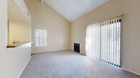Located at 3571 Madison St in Riverside, CA, this two-story, 3-bedroom, 2-bathroom home offers a thoughtfully arranged floor plan across two floors. The main level serves as the primary living area, featuring a spacious living room with dramatic vaulted ceilings, soft carpeting, and a cozy fireplace. Large sliding glass doors with vertical blinds fill the room with natural light and provide outdoor access. Adjacent to the living room, a pass-through kitchen with white cabinetry, granite-style countertops, and a skylight panel ceiling offers a connected and functional layout. A carpeted staircase with a railing leads to the upper level. The three bedrooms are carpeted and finished in warm neutral tones, each featuring sliding-door closets. The primary bedroom includes a convenient en-suite bathroom. Both bathrooms are finished with wood-look vinyl flooring, white cabinetry, and tub-shower combinations. Additional hallways connect the rooms across both levels, contributing to an organized and accessible flow throughout the home. The overall ambiance is clean, bright, and neutral, offering a comfortable and move-in-ready living environment.