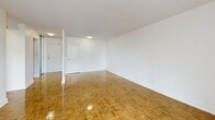 Located at 1110 Caven St in Mississauga, Ontario, this 3-bedroom, 1-bathroom unit offers a functional and well-organized single-floor layout. Polished parquet flooring flows consistently throughout the living areas and bedrooms, lending warmth and a classic character to the space. The open living area is bright and airy, benefiting from large floor-to-ceiling windows and a sliding glass door that fill the room with natural light and offer views of the surrounding cityscape. The kitchen is neatly appointed with white shaker-style cabinetry extending to the ceiling for ample storage, a light blue subway tile backsplash, dark countertops, and a full suite of stainless steel appliances including a refrigerator, stove, and microwave. Tile flooring grounds the kitchen area cleanly. The primary bedroom is generously proportioned, featuring a large window with an urban outlook and baseboard heating. The additional bedrooms are bright and well-sized with the same parquet flooring and clean white walls. The bathroom features a full soaker tub and shower enclosed in crisp white subway tile with chrome fixtures. Two hallways connect the rooms efficiently, and the unit's clean, neutral palette throughout creates a bright and move-in-ready atmosphere.