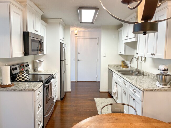 Kitchen with fridge, microwave, dishwasher, oven, and stove. - 29 Great Wood Ct