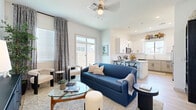 Located at 1620 N Trekell Rd in Casa Grande, Arizona, this thoughtfully designed single-story home offers 2 bedrooms and 3 bathrooms within a comfortable and efficiently planned layout. The open-concept living, dining, and kitchen area serves as the heart of the home, bathed in natural light from large windows and a sliding glass door that opens to the outdoors. Light wood-tone flooring flows seamlessly throughout, complementing the bright white walls and modern finishes.

The kitchen is a standout feature, showcasing two-tone cabinetry — crisp white uppers paired with greige lowers — topped with clean white countertops. A central island with bar seating, stainless steel appliances, a built-in pantry, and globe pendant lighting complete this functional and attractive space.

The primary bedroom is a serene retreat with its own walk-in closet and an en-suite bathroom featuring a dual-sink vanity with grey cabinetry, a glass-enclosed walk-in shower, and direct access to a dedicated walk-in closet. The second bedroom is well-proportioned with natural light and closet access. A second full bathroom with a tub-shower combination and grey vanity serves additional occupants. A dedicated laundry room and a hallway with multiple closets add practical convenience to this well-appointed home.