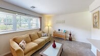 Located at 5597 Heritage Court Drive in Wilmington, Delaware, this one-bedroom, one-bathroom residence offers a well-organized, single-floor layout designed for comfortable everyday living. The living room is a welcoming space featuring carpet flooring, neutral walls, and a large window that invites natural light and outdoor views, creating a bright and relaxed atmosphere. The kitchen is efficiently designed with warm wood cabinetry, light countertops, a double stainless steel sink, and standard appliances including a range and overhead microwave. Wood-look flooring adds a practical touch to this functional cooking space. The bedroom is generously proportioned, featuring soft carpet flooring, a window with natural light, and direct access to a dedicated walk-in closet. The closet is carpeted and equipped with a full-length hanging rod and shelving, offering ample storage. The bathroom is clean and straightforward, featuring a tub-shower combination, a toilet, a single vanity sink, and a mirrored medicine cabinet. Throughout the residence, the neutral color palette and consistent finishes contribute to a cohesive and practical living environment, making this a well-appointed home in a convenient Wilmington location.