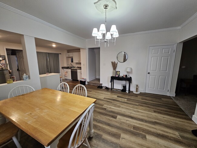 Spacious dining area with high ceilings and plenty of seating. Door is stairway to bedrooms - 149 W Sheridan Ave