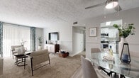Located at 2814 De Mel Ave. in Louisville, KY, this single-floor 2-bedroom, 1-bathroom home offers a thoughtfully designed layout that maximizes comfort and functionality. The living room is bright and welcoming, featuring plush carpet flooring, a textured ceiling, and large sliding glass doors dressed with patterned curtains that invite natural light into the space. It flows seamlessly into a dedicated dining area accented by a bold navy blue feature wall and a ceiling fan, creating a distinct yet open atmosphere.

The kitchen is outfitted with crisp white cabinetry, granite-style countertops, wood-look flooring, and stainless steel appliances including a range, microwave, and oven — ideal for everyday cooking. The primary bedroom is a spacious retreat highlighted by a striking navy accent wall and in-unit washer and dryer hookups, adding exceptional convenience. The second bedroom features neutral tones, carpeted floors, and a built-in closet. Both bedrooms are generously sized and filled with natural light from well-appointed windows.

The bathroom is clean and modern, featuring tile flooring, a granite-topped vanity with white cabinetry, a framed mirror, and a tub-shower combination. A hallway and dedicated closet complete the efficient floor plan of this move-in-ready Louisville home.