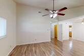 Located at 2300 General Meyer Ave in New Orleans, LA, this two-story home offers four bedrooms and three bathrooms across two well-proportioned floors. The main level provides the larger share of the living space and includes a welcoming entrance, a living room with vaulted ceilings and a ceiling fan, and light-toned hardwood-style flooring that flows throughout. The combined kitchen and dining area features warm oak cabinetry, granite-style countertops, a double basin sink, and a dishwasher, with a pantry and adjacent dining room nearby. A patio provides outdoor access from the ground floor. The upper level houses additional bedrooms, each carpeted and equipped with ceiling fans, offering a comfortable and private retreat. The primary bedroom includes natural light from a window with outdoor views. Nine closets are distributed throughout the home, ensuring ample storage. Three full bathrooms, each featuring a tub-shower combination with clean white finishes, serve the home's occupants. Additional practical spaces include a laundry room, utility room, and multiple hallways connecting the layout efficiently. Two staircases — one carpeted — link the floors. Ceiling fans are found in nearly every room, a practical feature well-suited to the New Orleans climate.