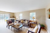 Located at 1600 West Creek Village Drive in Elkton, Maryland, this single-floor, 3-bedroom, 2-bathroom home offers a thoughtfully designed layout with comfortable living spaces throughout. The spacious living room is a standout feature, highlighted by a corner fireplace, plush carpeting, and multiple windows that invite abundant natural light. Sliding glass doors open to an outdoor patio, offering views of the surrounding community. The dining area sits adjacent to the living space and features tile flooring and a window overlooking the exterior, creating a bright and inviting setting for meals. The kitchen is equipped with warm wood cabinetry and connects conveniently to the dining area. The primary bedroom is generously sized, while two additional bedrooms offer flexibility for various needs, each with carpeted floors, ceiling fans, and natural light. Two full bathrooms serve the home, each featuring a single-sink vanity with wood cabinetry and a shower-tub combination. A dedicated laundry room houses a full-size washer and dryer. Five closets are distributed throughout the home, providing ample storage. Two hallways connect the rooms with ease, finished in neutral tones that complement the home's cohesive, warm color palette. An in-unit laundry room adds everyday convenience to this well-rounded home.