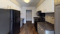 This single-floor residence at 2900 El Camino Ave in Las Vegas, Nevada offers a practical and well-organized layout suited for comfortable everyday living. The spacious living room is highlighted by a classic brick fireplace, plush carpeting, and a sliding glass door that opens to a private balcony, allowing natural light to fill the space. A ceiling fan enhances comfort, and the open feel of the room provides flexible arrangement options. The kitchen is a functional galley-style space featuring white upper cabinetry, gray lower cabinets, granite-style countertops, a decorative tile backsplash, and dark wood-style flooring. Black appliances, including a refrigerator, range, microwave, and dishwasher, complete the kitchen's cohesive design. The bedrooms are generously sized, each finished with soft carpeting, neutral-toned walls, and textured ceilings. Windows in the bedrooms allow for natural light and ventilation. Two bathrooms serve the residence, both featuring dark wood-style flooring, gray cabinetry, and granite-style countertops. One bathroom includes a shower-tub combination, while the other features a standalone shower stall. Together, these spaces create a clean, move-in-ready home in a central Las Vegas location.