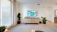 Located in Whittier, CA, this one-bedroom, one-bathroom residence on Skylark Circle offers a thoughtfully designed single-floor layout that maximizes comfort and functionality. Light wood-style flooring flows through the main living areas, complementing the bright, neutral palette found throughout the space.

The combined kitchen and living room serves as the heart of the home. The kitchen is outfitted with crisp white cabinetry, stainless steel appliances including a gas range, microwave, refrigerator, and dishwasher, along with a classic subway tile backsplash and light quartz countertops. The adjoining living area features a welcoming arrangement with a glazed door that invites abundant natural light and provides access to the outdoors.

The bedroom is a serene retreat, featuring a tray ceiling, a ceiling fan, and multiple windows that frame views of the surrounding greenery. Soft carpeting adds warmth underfoot, and a dedicated walk-in closet with dual hanging rods and built-in shelving offers generous storage.

The bathroom is clean and modern, featuring a white vanity with ample cabinetry, a well-lit mirror, and light wood-style flooring that echoes the rest of the home. A hallway connects the rooms efficiently, completing this cohesive and practical floor plan.