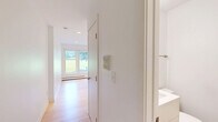 Studio D at 1550 Eustis Street offers a thoughtfully designed, efficiently laid-out studio in Saint Paul, MN. The space features light-toned hardwood flooring throughout the main living area, contributing to a bright and clean aesthetic complemented by crisp white walls and recessed lighting.

The compact kitchenette is neatly tucked into an alcove and is well-equipped with white cabinetry, stainless steel appliances including a refrigerator, dishwasher, built-in microwave, and a single-basin sink — providing all essential cooking and storage needs within a minimal footprint.

The main living area is open and versatile, benefiting from a window that invites natural light and frames a view of the surrounding greenery. A wall-mounted mini-split air conditioning unit and baseboard heating ensure year-round comfort, while recessed ceiling lights keep the space feeling airy and well-lit.

The bathroom is finished with neutral tile flooring, a white vanity with under-cabinet storage, a toilet, and a glass-door shower stall — clean and functional in design. Throughout the unit, the consistent use of white tones and natural wood creates a cohesive, modern, and minimalist ambiance ideal for a single occupant seeking a streamlined living environment in Saint Paul.