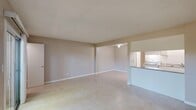 Located at 1961 Howe Ave in the Arden-Arcade neighborhood of Sacramento, CA, this single-story, one-bedroom, one-bathroom unit offers a functional and straightforward layout. The open-concept living room and kitchen area forms the heart of the home, providing a spacious feel with light-toned tile flooring running throughout. The living area features a ceiling fan and neutral beige walls with clean white baseboards, creating a bright and airy ambiance. A pass-through counter connects the living space to the kitchen, which is outfitted with white cabinetry, a coil-burner electric range, a full-size refrigerator, a built-in sink with countertop workspace, and an overhead range hood—all arranged in an efficient galley-style configuration. The bedroom is a well-proportioned, quiet retreat featuring a window with views of surrounding greenery, allowing natural light to fill the room. A dedicated closet provides convenient storage. The bathroom is clean and simply appointed, featuring tile flooring, a bathtub, and a towel bar. A textured ceiling is consistent throughout the unit. The overall design is practical and move-in ready, suited for comfortable single-occupancy living in a well-established California neighborhood.