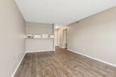 This single-floor, 2-bedroom, 2-bathroom residence in Montgomery, Alabama offers a practical and comfortable layout designed for efficient living. Wood-look hardwood flooring flows consistently throughout the main living areas and bedrooms, providing a cohesive and clean aesthetic. Neutral taupe walls and white trim complement the overall design, while textured ceilings add depth to each room.

The open living area connects seamlessly to the kitchen, which features granite countertops with a striking blue-gray pattern, white cabinetry, and a bright window that allows natural light to pour in. A hallway lined with a built-in shelved closet leads toward the bedrooms, offering convenient storage.

Both bedrooms are well-sized, each equipped with ceiling fans with light fixtures and windows that bring in natural light. The primary bedroom includes a spacious double-door closet. The second bedroom mirrors the design with its own window and ceiling fan.

Each of the two bathrooms is finished with granite-topped white vanities, framed mirrors, mosaic tile flooring, and a tub-shower combination with grab bars — a practical and thoughtful touch. The consistent finishes across both bathrooms create a unified, polished look throughout the home.