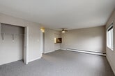 Located in Richmond, BC, this 1-bedroom, 1-bathroom apartment offers a practical and comfortable single-floor layout. The generously sized bedroom is a standout feature, providing ample space for rest and relaxation. It is fitted with soft grey carpeting, neutral-toned walls, a ceiling fan with integrated lighting, and two windows that invite natural light and frame views of surrounding greenery. Two closets offer convenient storage solutions within the unit.

The kitchen is efficiently designed with white cabinetry, dark countertops, a stylish black tile mosaic backsplash, and a stainless steel range, providing a functional cooking space. A pass-through window connects the kitchen to the main living area, enhancing the sense of openness throughout.

The bathroom is clean and modern, featuring a full soaker tub with an overhead shower, white tile surround accented by a black mosaic border tile, and wood-look flooring, lending a polished finish to the space.

Throughout the unit, baseboard heating ensures year-round comfort. Neutral tones and consistent finishes create a cohesive, move-in-ready aesthetic. A hallway connects the key areas of the home, contributing to an efficient and well-organized floor plan ideal for individuals or couples.