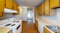 This 740 square foot apartment offers a practical living solution with its efficient layout. The single-story unit comprises two bedrooms, two bathrooms, and a well-designed kitchen. The primary bedroom, measuring 130 square feet, provides ample space for a comfortable retreat.

The galley-style kitchen features light wood cabinetry, white appliances, and durable wood-look flooring. It offers sufficient counter space and storage options for meal preparation and organization. The living areas and bedrooms are fitted with neutral-toned carpeting, creating a cozy ambiance throughout.

The bathrooms are equipped with essential fixtures and appear to have a clean, white finish. The apartment's neutral color palette, predominantly in shades of white and beige, allows for personalization and versatile decorating options.

Large windows in the bedrooms provide natural light, enhancing the sense of space. The apartment includes a closet for additional storage. The textured ceiling and simple light fixtures maintain a modest, functional aesthetic.

Located at 2821 S Emporia St in Wichita, KS, this apartment offers a practical living space ideal for small families, couples, or individuals seeking an efficient and low-maintenance home. Its compact design maximizes usability while maintaining comfort and functionality.