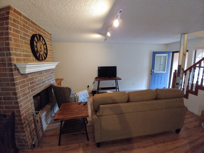 The dining area looks over into the living room. Plenty of natural light! - 2415 Idlewilde Dr