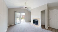Located at 1717 Somerset Pl in Hurstbourne Acres, Kentucky, this single-story residence offers a thoughtfully arranged layout with a range of practical features throughout. The living area serves as the centerpiece of the home, showcasing vaulted ceilings that lend a sense of openness and volume to the space. A tile-surround fireplace with glass doors provides a focal point, while a ceiling fan overhead and a sliding glass door leading to an outdoor patio contribute both comfort and natural light. Views of the surrounding neighborhood are visible through the patio door.

The kitchen is equipped with white cabinetry, granite-look countertops, a black electric range with overhead ventilation, and light wood-style flooring, creating a clean and functional cooking environment. Bedrooms are carpeted and feature mirrored sliding closet doors with built-in wire shelving systems, offering organized storage. The primary bedroom includes direct access to a private bathroom.

The bathroom features a full tub-shower combination with white tile surround. An in-unit laundry area with overhead cabinetry and wood-style flooring adds convenience. Throughout the home, neutral tones and consistent finishes create a cohesive, move-in-ready ambiance.