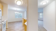 This well-designed single-story residence in San Ramon, California offers 1050 square feet of living space, efficiently arranged to accommodate five bedrooms and two bathrooms. The home's layout includes a hallway, two closets, and an open-concept area combining the dining room, kitchen, and living room.

The primary bedroom, measuring 140 square feet, provides a generous private retreat. Throughout the home, neutral-toned walls and carpeting create a bright, airy atmosphere. Large windows in several rooms allow ample natural light and offer views of the surrounding neighborhood.

The bathrooms feature modern fixtures, including a combination tub-shower with curved shower rods, white porcelain toilets, and wood-toned vanities with ample storage. The kitchen boasts light wood cabinetry, contrasting white appliances, and durable laminate flooring that extends into other areas of the home.

The dining area is illuminated by a contemporary chandelier, adding a touch of elegance to the space. Closets with wooden rods provide essential storage solutions. The overall design emphasizes functionality and comfort, making efficient use of the available square footage to create a welcoming family home.