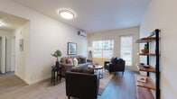 Located on NE Salmon Creek Ave in Vancouver, Washington, this single-floor residence offers a well-designed layout with modern finishes and a functional, comfortable living environment. The living area serves as the heart of the home, featuring wood-style plank flooring, neutral walls, and large windows that invite abundant natural light. A wall-mounted mini-split system provides efficient climate control, and a private exterior entry door adds convenience. The kitchen is thoughtfully appointed with taupe shaker-style cabinetry, stainless steel appliances including a refrigerator, electric range, and microwave, and a white quartz peninsula countertop with bar seating — ideal for casual dining or meal prep. The space includes two bedrooms, each carpeted for comfort and outfitted with windows that bring in natural light. Both bathrooms mirror each other in design, featuring wood-toned vanity cabinetry, white quartz countertops, and a tub-shower combination with clean, classic fixtures. Wood-look flooring extends through the bathrooms, maintaining visual continuity. The overall aesthetic is clean and contemporary, with a neutral palette that creates a bright, welcoming ambiance throughout the home.