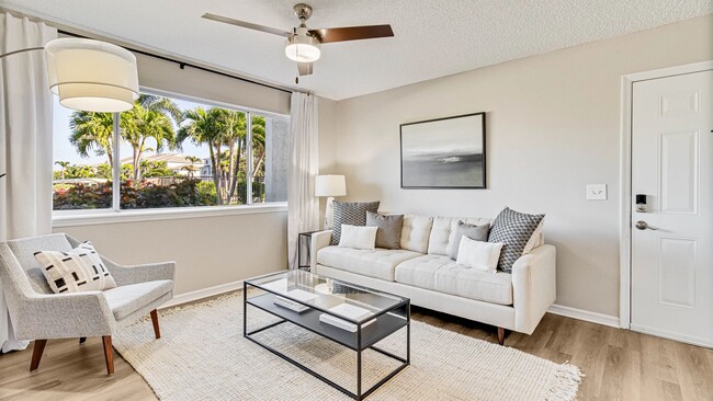 Spacious living area with connecting dining and kitchen areas. - Lexington Palms at the Forum