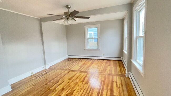 Spacious sunny living room with beautiful hardwood flooring. - 33 Foxhill Ave