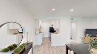 Located at 1101 Clayton Ln in Austin, TX, this thoughtfully designed single-story home offers a cohesive, modern aesthetic across a well-organized layout that includes a living room, dining room, dedicated office, bedroom, kitchen, bathroom, hallway, and closet. Light wood-look flooring flows throughout, tying the spaces together with a clean, contemporary feel. The living room features a ceiling fan, recessed lighting, a patterned area rug, and a window that brings in natural light. The adjacent dining area opens toward a glass-paneled front door, allowing additional light to filter through. The galley-style kitchen is outfitted with white shaker cabinets, quartz countertops, a herringbone tile backsplash, a gas range, and stainless steel appliances. The dedicated office provides a quiet workspace with a ceiling fan and natural light from a side window. The bedroom is a calm retreat with a ceiling fan, a window with blinds, recessed lighting, and access to a closet. The bathroom features large-format marble-look tile in the walk-in shower, complemented by matte black fixtures and a built-in niche. Throughout the home, crisp white walls, recessed lighting, and consistent finishes create a bright and functional living environment.