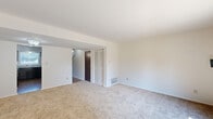 Located at 1301 N Whitcomb Ave in Indianapolis, Indiana, this two-story home offers three bedrooms and two bathrooms thoughtfully distributed across two well-proportioned floors. The main level features a bright living room with plush carpeting and a sliding glass door that opens to a fenced backyard, filling the space with natural light and providing easy outdoor access. The kitchen is equipped with dark espresso cabinetry, light granite-style countertops, a stainless steel sink, and wood-look flooring, complemented by a window that allows natural light to brighten the workspace. A hallway on the main floor connects key living areas, with wood-look flooring and a carpeted staircase leading to the upper level. Upstairs, the generously sized primary bedroom features carpeting, a large closet with louvered bifold doors and built-in shelving, and a window overlooking the exterior. The two additional bedrooms are also carpeted and offer comfortable proportions with closet access. The two bathrooms include one with a full tub-shower combination featuring classic white tile surround, and a second bathroom with a dark vanity and granite-style countertop. A dedicated closet provides extra storage, rounding out this practical and well-laid-out Indianapolis home.