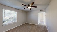 Located at 330 Waymore Dr in El Paso, Texas, this single-story, 2-bedroom, 2-bathroom home offers a practical and well-organized layout. The floor plan includes a living room, kitchen, hallway, in-unit laundry, two bedrooms, two closets, and two full bathrooms.

The kitchen stands out with updated gray shaker-style cabinetry, light quartz countertops, a classic white subway tile backsplash, and light wood-look vinyl flooring. A stainless steel range hood and black electric range complete the functional cooking space.

Both bedrooms feature neutral-toned carpet, textured ceilings, ceiling fans with light fixtures, and windows that allow natural light to filter in. The primary bedroom offers a comfortable footprint with direct access to adjacent spaces. The second bedroom also features a window with blinds and a cinder block accent wall, giving it a distinctive character.

The bathrooms are finished with white subway tile tub surrounds and vanities topped with speckled quartz countertops, paired with gray cabinetry consistent with the kitchen design. A large mirror and vanity lighting complete each bathroom.

Throughout the home, neutral gray walls, white baseboards, and carpeted floors in the main living areas create a cohesive and clean aesthetic. The inclusion of in-unit laundry adds a convenient, practical feature to this compact yet efficiently designed home.