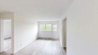 Located at 6965 Rue De Choisy in Montréal's Rosemont–La Petite-Patrie area, this single-floor unit offers three bedrooms, one bathroom, a kitchen, and a private balcony. The interior is finished with light-toned hardwood flooring throughout, paired with clean white walls that create a bright, airy atmosphere across every room. The spacious primary bedroom is generously proportioned, featuring a large sliding window that frames views of surrounding greenery, along with a baseboard heating unit. The two additional bedrooms are well-sized, each with their own windows overlooking the lush outdoor surroundings, providing ample natural light. The kitchen is efficiently laid out with white cabinetry, dark countertops, a subway tile backsplash, and includes a refrigerator, electric stove, and sink — offering a functional and modern cooking space. The bathroom is finished with full white square wall tiling, hardwood-style flooring, and a clean, minimalist design. The open living area benefits from a wide window and balcony door, filling the space with natural light and offering pleasant green views. The unit's consistent, neutral palette and updated finishes give the space a fresh, move-in-ready feel.
