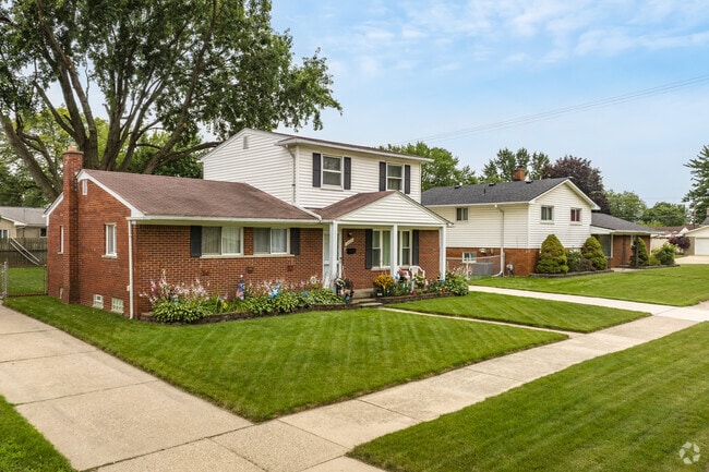 Raised brick ranch homes with manicured lawns are common in Westland.