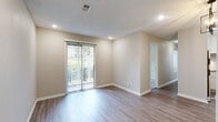 Located at 3310 Medlock Bridge Rd in Peachtree Corners, GA, this single-floor, two-bedroom, one-bathroom residence offers a well-organized layout with modern updates throughout. The living room is bright and open, featuring wood-look laminate flooring, recessed lighting, and a sliding glass door that opens to a private balcony overlooking lush greenery, filling the space with natural light. The kitchen is thoughtfully updated with white shaker cabinetry, granite countertops, a subway tile backsplash, and stainless steel appliances, including a range with microwave overhead and a refrigerator. Both bedrooms are carpeted and include ceiling fans, natural light from windows with views of surrounding foliage, and generous closet space with double-door closets. The primary bedroom offers a comfortable and well-proportioned retreat. The full bathroom features a soaking tub and shower combination with floor-to-ceiling large-format tile in a neutral wood-grain finish and brushed nickel fixtures. Throughout the residence, neutral tones and clean finishes create a cohesive and move-in ready ambiance, well-suited for comfortable everyday living.