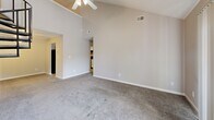 Located at 9510 Ridgeside Dr in Louisville, KY, this two-floor home offers three bedrooms, one bathroom, and a well-utilized layout across its main and upper levels. The main floor comprises the majority of the living space and includes a spacious living room highlighted by dramatic vaulted ceilings and a ceiling fan, creating an open and airy atmosphere. A sliding glass door in the living room leads directly to an outdoor deck, allowing natural light to pour in and providing easy access to the exterior. The kitchen features ample white cabinetry with wood trim accents, light countertops, tile flooring, and black appliances including a gas range, dishwasher, and refrigerator. It connects conveniently to the rest of the main floor via an open archway. The three carpeted bedrooms are finished in neutral tones with textured ceilings and windows that bring in natural light. The primary bedroom is a comfortable size and includes a ceiling fan. Two closets provide dedicated storage throughout the home. The full bathroom includes a combined tub and shower unit with tile flooring. A utility room and hallway round out the functional layout, making this a practical and well-organized home.