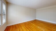 Located in the vibrant Columbia Heights neighborhood of Washington, DC, Unit 731 at 1629 Columbia Rd NW is a well-appointed studio unit offering an efficient and thoughtfully designed single-floor layout. The open living area is anchored by warm, polished hardwood flooring that runs throughout, complemented by crisp white walls and clean white baseboards that give the space a bright, airy feel. A pair of street-facing windows allows natural light to fill the living area, offering views of the surrounding urban streetscape. The kitchen is outfitted with rich dark wood cabinetry, a white countertop with an undermount stainless steel sink, and a full suite of stainless steel appliances including a gas range, over-the-range microwave, and dishwasher. Light-toned tile flooring grounds the kitchen area. The bathroom features classic white subway tile and connects to a walk-in closet equipped with built-in shelving and hanging rods, providing ample storage. A dedicated entrance leads into the unit, establishing a clear transition into the living space. The overall layout is compact yet functional, making efficient use of every square foot while maintaining a clean, modern aesthetic throughout.